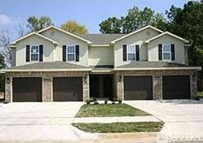 Siloam Springs townhouse for rent - A two-story house with a garage on the lower level.