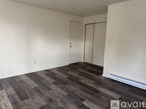 Salem apartment for rent - A room with a wooden floor and white walls.
