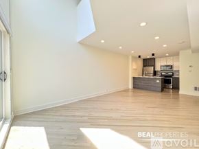 Chicago condo for rent - A white walk-in pantry with shelving and a wood floor.