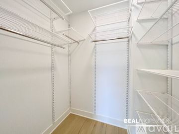 Chicago condo for rent - A modern kitchen with a stainless steel refrigerator, a stove, and a microwave above the oven.