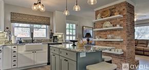 Boone house for rent - A kitchen with a brick column and a countertop with a sink.