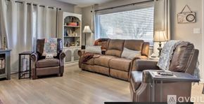Boone house for rent - A living room with brown leather furniture and a wooden floor.