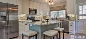 Boone house for rent - A kitchen with a refrigerator, microwave, and a counter with a sink.