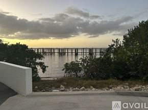 Fort Myers condo for rent - A living room with a table, chairs, and a television.