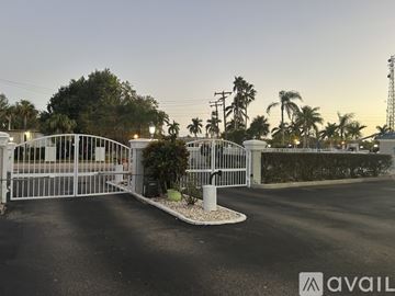 Fort Myers condo for rent - A living room with a brown leather couch and a painting on the wall.