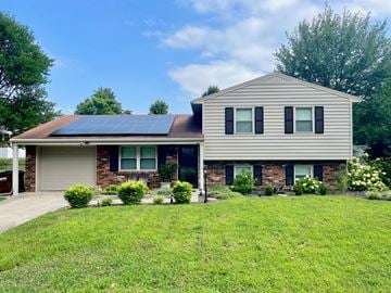 Louisville house for rent - A house with a grey roof and a garage door.