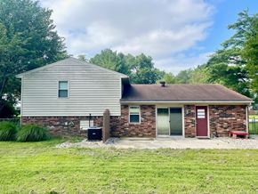 Louisville house for rent - A house with a grey roof and a red door.