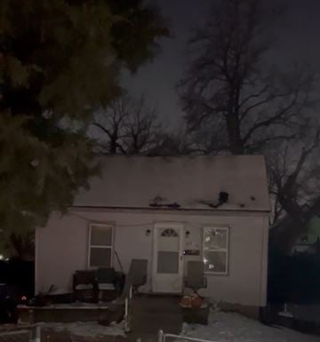 St.Louis house for rent - A house with a snow-covered roof and a dark sky.
