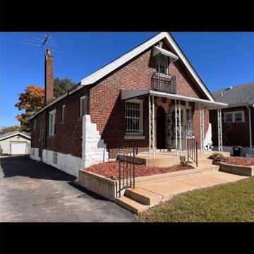 St. Louis house for rent - A red brick house with a white porch.