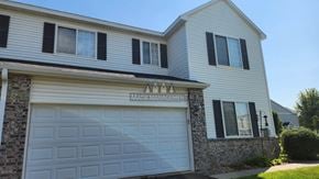 Rochester apartment for rent - A house with a garage door and a sign that says "MATIC MANAGEMENT".