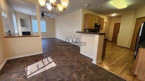 Rochester apartment for rent - A living room with a brown floor and a ceiling fan.