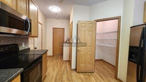 Rochester apartment for rent - A kitchen with a black counter top and wooden cabinets.