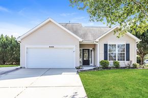 Burlington house for rent - A house with a white garage door and a black window.