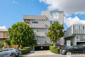 Los Angeles apartment for rent - A modern building with a grey facade and a black car parked in front.