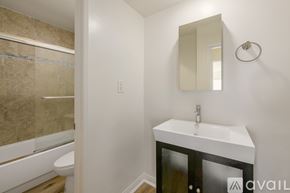 Los Angeles apartment for rent - A bathroom with a sink, mirror, and bathtub.