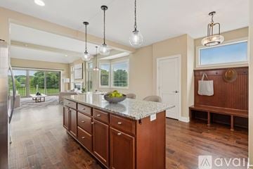 Plymouth house for rent - A kitchen with wooden floors and a dining table with chairs.