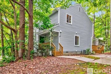 Raleigh house for rent - A kitchen with white cabinets and a granite countertop.