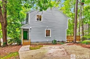 Raleigh house for rent - A kitchen with a refrigerator, cabinets, and a window.