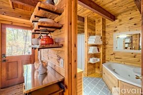 Demorest house for rent - A wooden cabin with a hot tub and a window.