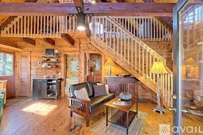 Demorest house for rent - A living room with a couch, a coffee table, and a staircase.