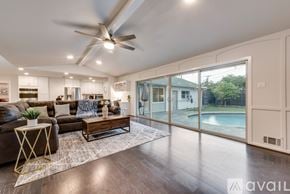 Dallas house for rent - A modern living room with a pool outside the window.