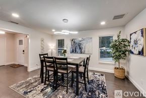 Dallas house for rent - A dining room with a table set for four.