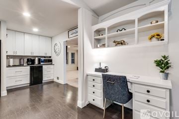 Dallas house for rent - A modern kitchen with a black oven and white cabinets.