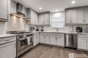 Dallas house for rent - A modern kitchen with a stainless steel dishwasher and oven.