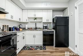 Nashville apartment for rent - A kitchen with white cabinets and black appliances.