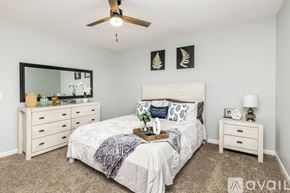 Nashville apartment for rent - A bedroom with a bed, dresser, and mirror.