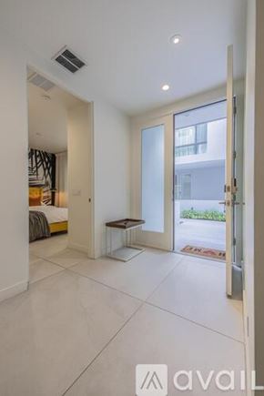 Scottsdale apartment for rent - A modern bedroom with a large bed and a glass door leading to a balcony.