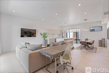 Scottsdale apartment for rent - A modern living room with a large couch and a dining table.