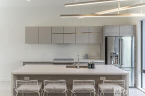 Scottsdale apartment for rent - A modern kitchen with a white table and chairs.