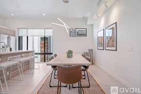Scottsdale apartment for rent - A modern dining room with a wooden table and chairs.