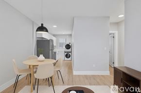 Miami apartment for rent - A modern dining room with a round table and chairs.