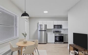 Miami apartment for rent - A modern kitchen with a dining table and chairs.