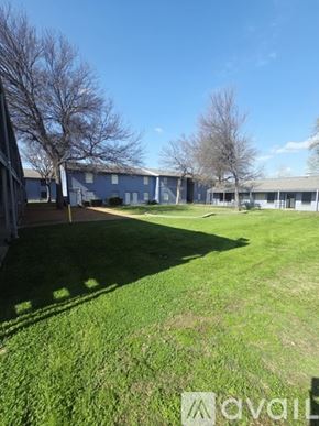 Dallas apartment for rent - A grassy field with a building in the background.