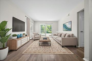 Lakewood apartment for rent - A living room with a couch, a coffee table, a TV, and a painting on the wall.