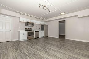 Tucson apartment for rent - A kitchen with white cabinets and a microwave above the stove.