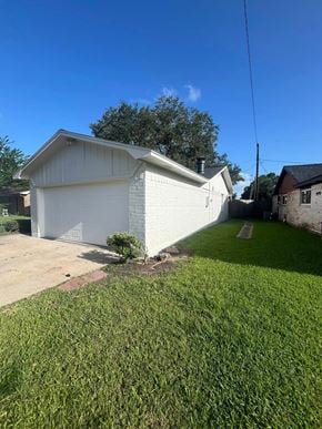 Bay City house for rent - A white garage with a grey roof is situated in a grassy area.