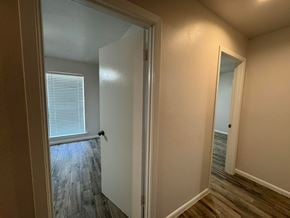 Bay City house for rent - A hallway with a door leading to a room with a window.