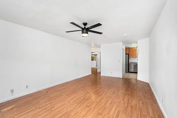 Kaneohe apartment for rent - A room with a ceiling fan and wooden flooring.