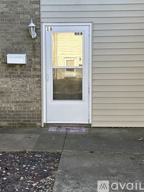 Pekin house for rent - A white door with a glass window is on the side of a building.