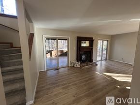 Chapel Hill house for rent - A living room with a fireplace and sliding glass doors.