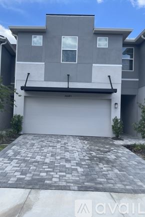 Lutz house for rent - A modern house with a garage and a driveway.