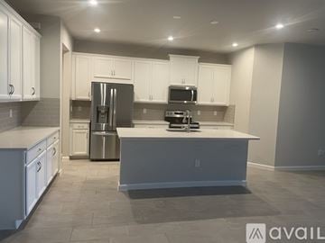 Lutz house for rent - A modern kitchen with white cabinets and stainless steel appliances.