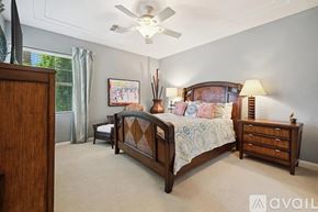 La Quinta house for rent - A bedroom with a large bed and a ceiling fan.