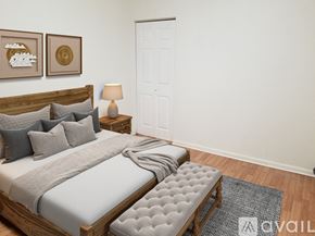 Cleveland apartment for rent - A bedroom with a large bed and a bench in front of it.