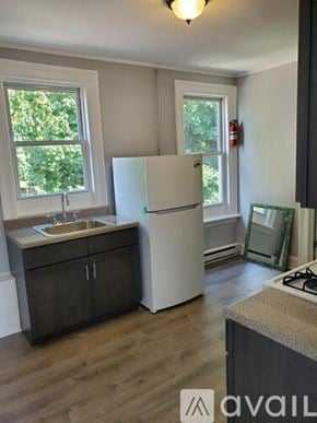Newburgh apartment for rent - A kitchen with a white fridge and wooden floors.