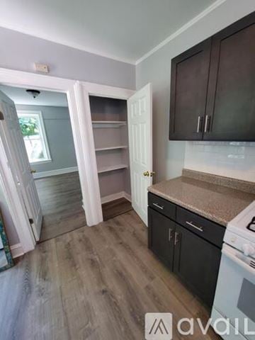 Newburgh apartment for rent - A kitchen with a white oven and black cabinets.
